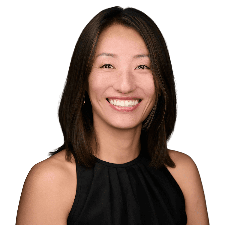 Smiling woman with shoulder-length hair in a sleeveless black top.